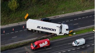 A truck's jackknifing on a dual carriageway leads to major traffic delays.