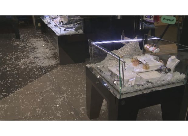 Employees at a jewellery store use a ring-sizing tool to chase away thieves.