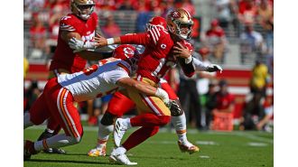 The San Francisco 49ers were defeated by the undefeated Kansas City Chiefs in a Super Bowl rematch, as shown in photos.