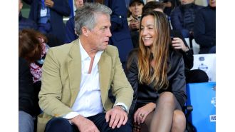Hugh Grant and his spouse Anna made a rare public appearance, showing their affection at a football game.