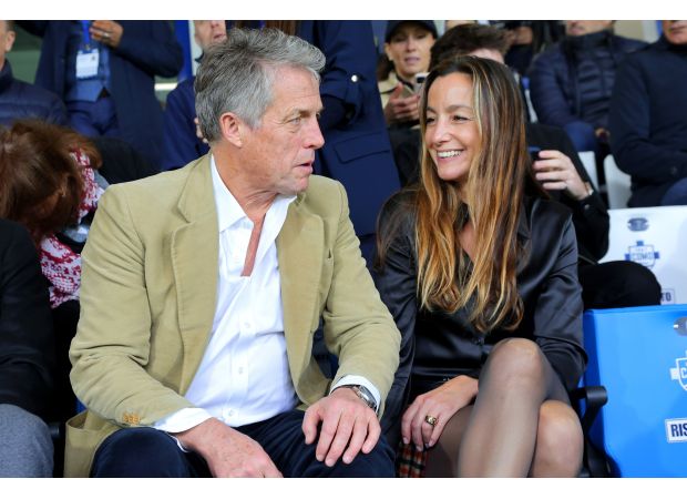 Hugh Grant and his spouse Anna made a rare public appearance, showing their affection at a football game.