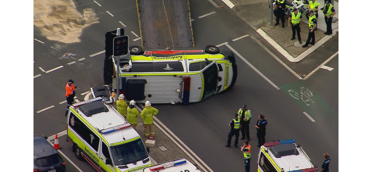 Four people were hurt when an ambulance overturned in Brisbane.