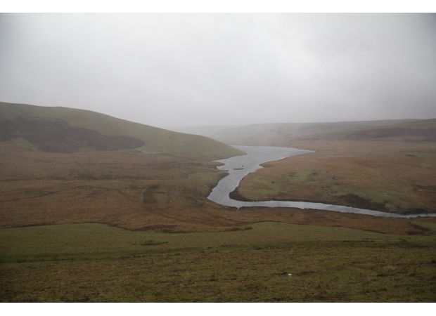 A person's body was found in a wetsuit in a reservoir in Wales.