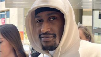 UK rapper charged with rape sends love to supporters as he exits court in Perth, Australia.
