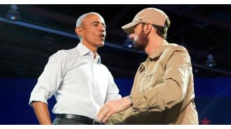 Former president Obama joins Eminem on stage, rapping along to his popular 2000s hit.