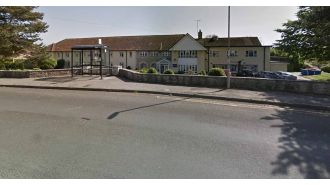 Nursing home cleared out due to serious event, causing emotional distress for staff outside.