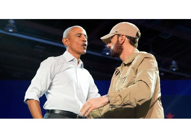 Former president Obama joins Eminem on stage, rapping along to his popular 2000s hit.