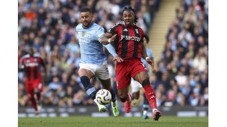Kyle Walker reaches out to Adama Traore after being defeated in a sprint race.