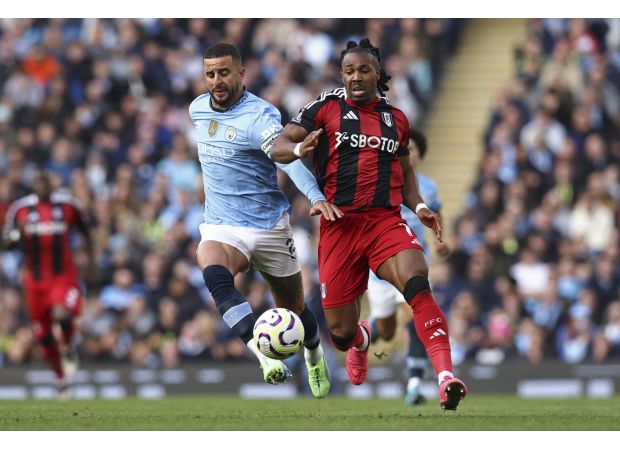 Kyle Walker reaches out to Adama Traore after being defeated in a sprint race.