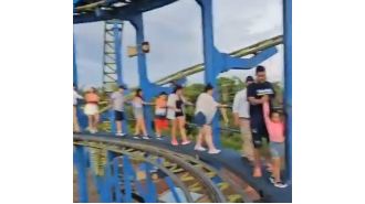 Scared riders exit rollercoaster on foot after being stuck 70ft above ground.