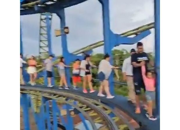 Scared riders exit rollercoaster on foot after being stuck 70ft above ground.