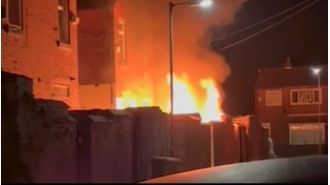 A fire destroys a house after vandals throw fireworks into their backyard, causing damage.