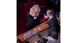 Adele is moved to tears when her music idol unexpectedly appears during her performance.
