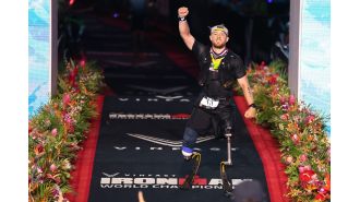 Billy Monger, a double amputee, sets new Ironman World Championship record despite being stung by a jellyfish.