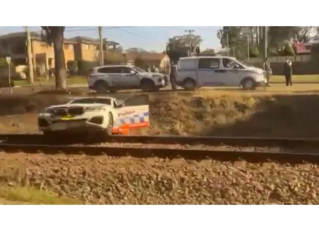 Cops escape train while pursuing biker in Sydney.