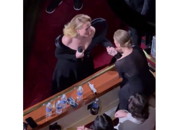 Adele is moved to tears when her music idol unexpectedly appears during her performance.