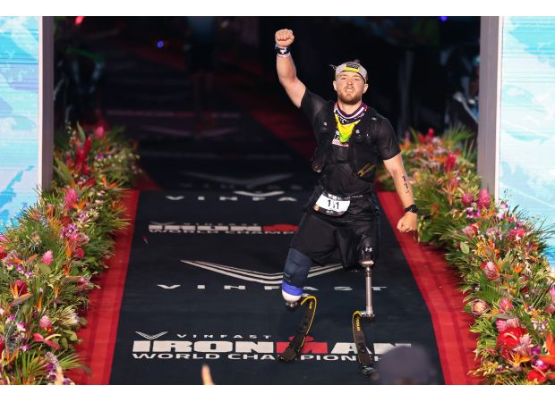 Billy Monger, a double amputee, sets new Ironman World Championship record despite being stung by a jellyfish.