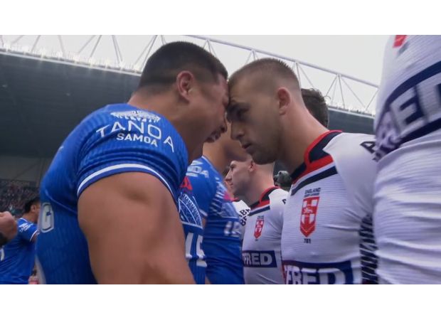 English rugby player clashes with opponent during intense Siva Tau dance in match against Samoa.