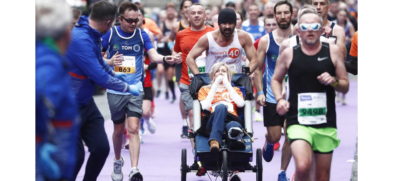 Actor Colin Farrell completes Dublin Marathon while pushing his friend in a wheelchair.