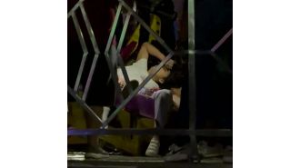 A huge fair swing malfunctions and collides with a barrier, causing it to break while in use.