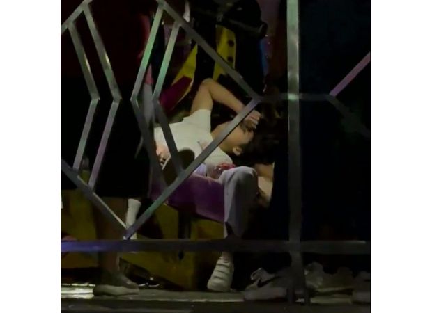 A huge fair swing malfunctions and collides with a barrier, causing it to break while in use.