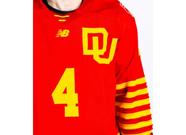 Denver hockey honors 75th anniversary with red and yellow uniform.