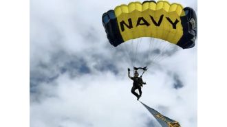 Footage depicts pre-crash scene of Navy parachutist colliding with family at Fleet Week event.