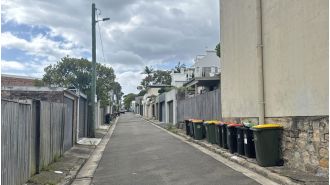 City official monitors neighborhoods for violators who may face $220 penalty for not following waste disposal regulations.