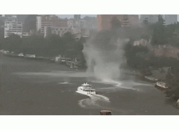 A breathtaking scene as a gustnado tears through Brisbane River amidst a fierce storm.