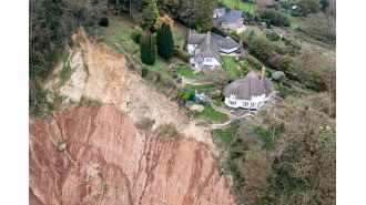 A cottage is in danger of falling off a 400ft cliff due to a huge landslide.