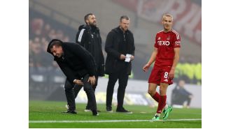 Celtic's Brendan Rodgers falls while kicking ball in victory over Aberdeen.
