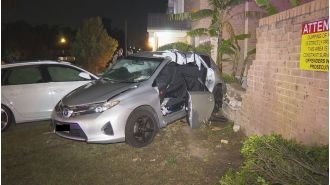 Two cars collide with brick fence, causing chaos in Sydney's western region.