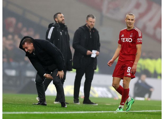 Celtic's Brendan Rodgers falls while kicking ball in victory over Aberdeen.