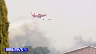 Two individuals facing charges after a nearby property was almost engulfed by a bushfire.
