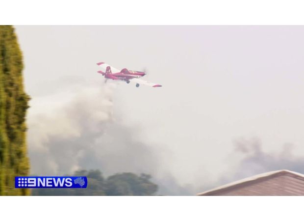 Two individuals facing charges after a nearby property was almost engulfed by a bushfire.