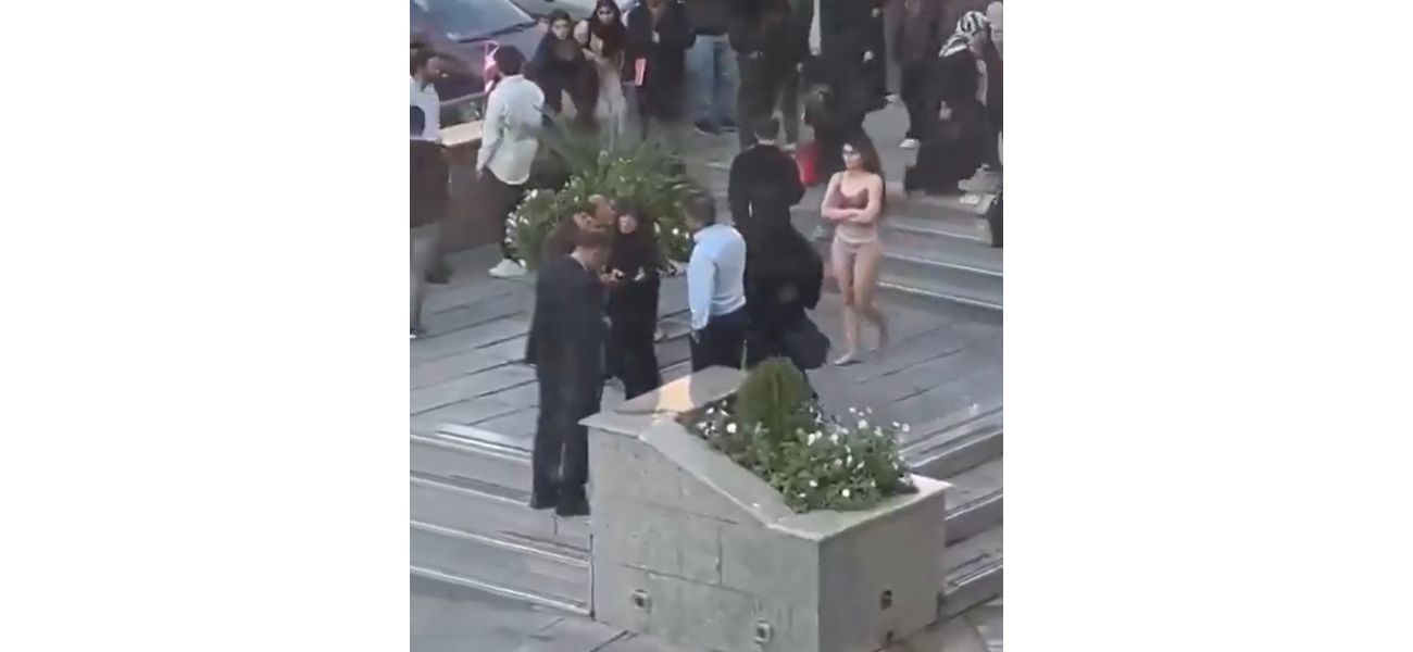 A woman in Iran undresses to her underwear in a demonstration at a university in Tehran.