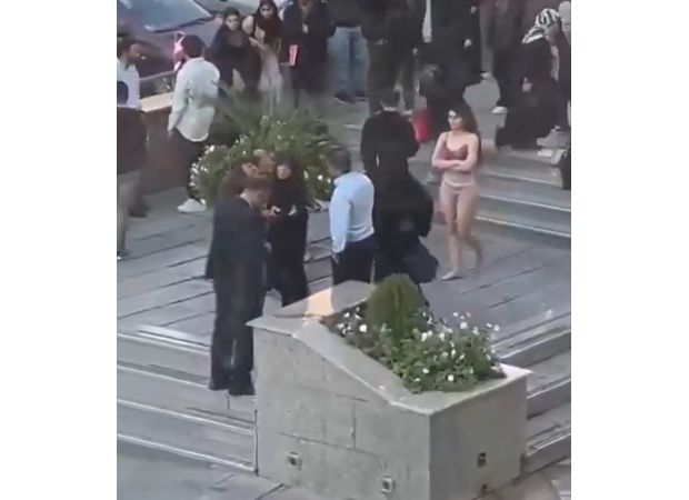 A woman in Iran undresses to her underwear in a demonstration at a university in Tehran.