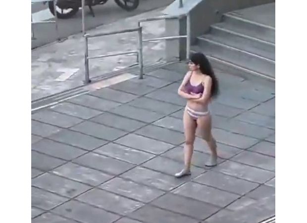 An Iranian student was forcefully taken into a car after removing her hijab and protesting in her underwear.