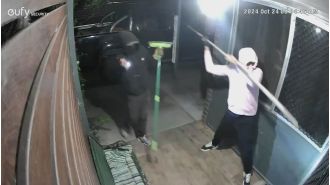 A group of people arrived at the house and forcefully entered through the front door.