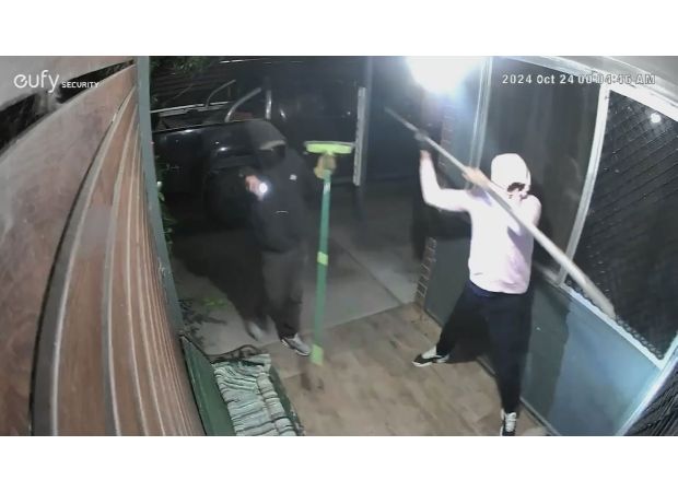 A group of people arrived at the house and forcefully entered through the front door.