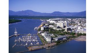 Two girls face charges after a woman in Cairns was reportedly threatened with scissors and physically attacked.