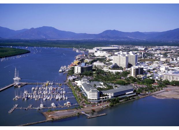 Two girls face charges after a woman in Cairns was reportedly threatened with scissors and physically attacked.