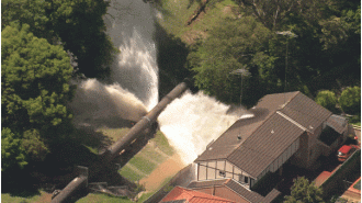 Water pipeline in Sydney breaks, flooding houses with a surge of water.