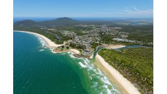 Murder charge for man after body of woman discovered in unit in NSW coastal town.