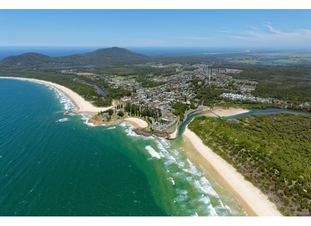 Murder charge for man after body of woman discovered in unit in NSW coastal town.