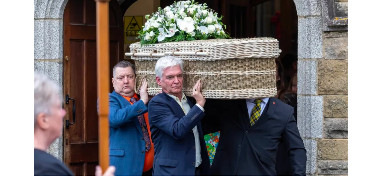 Phillip Schofield's wife supports him as he carries his mother's casket at her funeral.