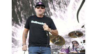 A 2000s rock group drops a supporting act from their tour due to their lead singer getting punched.