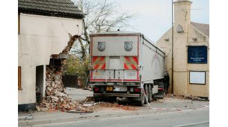 Truck veers off road, crashes into pub and house.