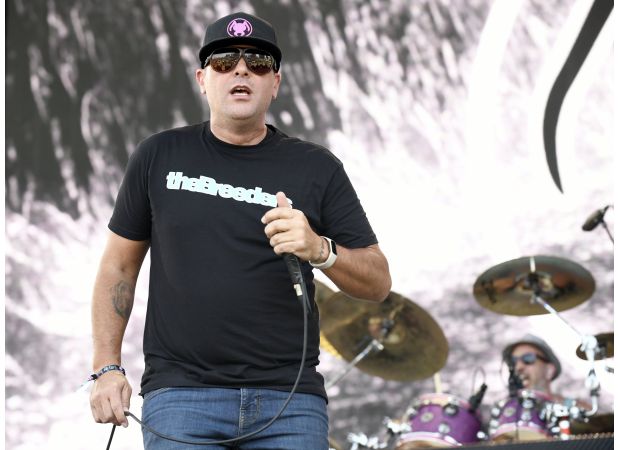 A 2000s rock group drops a supporting act from their tour due to their lead singer getting punched.