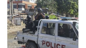 Haiti's main airport closed due to gunfire on plane.